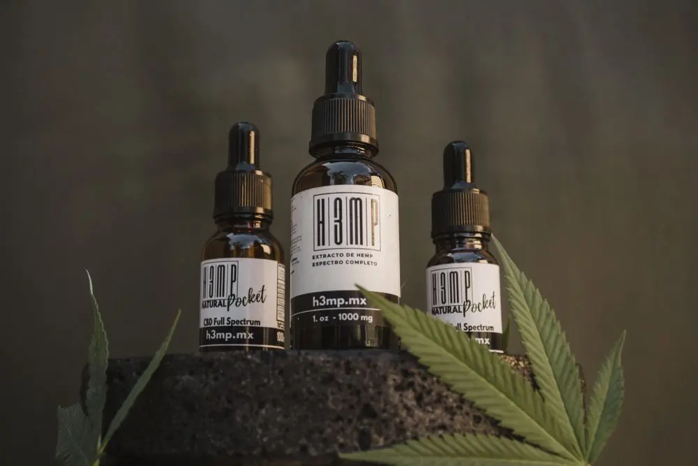 Hemp oil tincture bottles on a dark background
