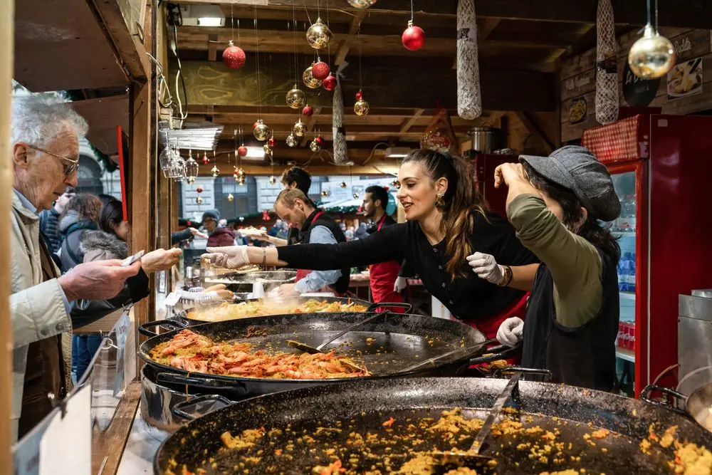 Busy food stall serving a queue of customers