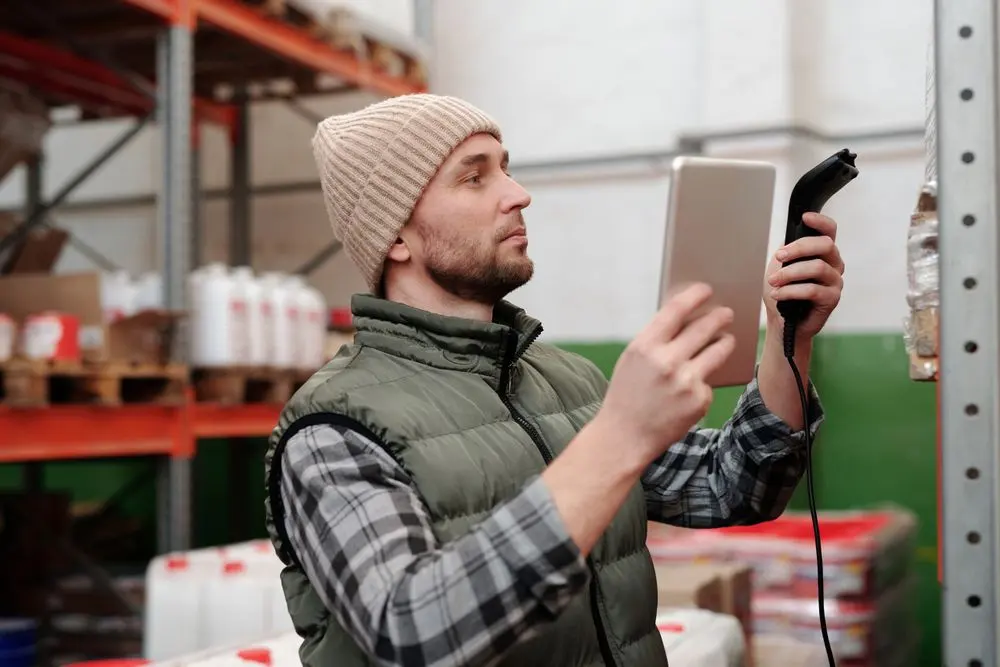 Warehouse worker checking stock with a barcode scanner