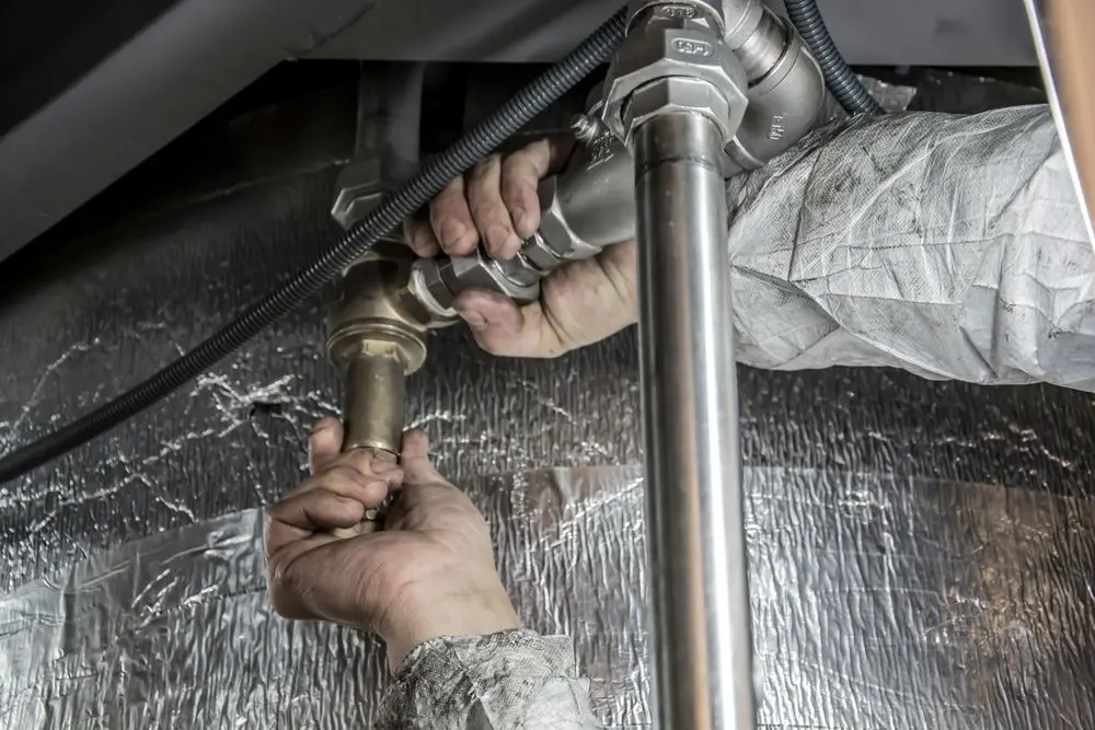Plumber fitting copper pipework with hand tools