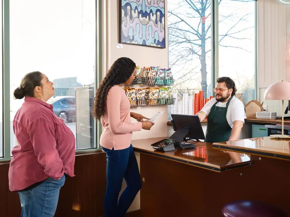 Staff serving customers at a restaurant counter