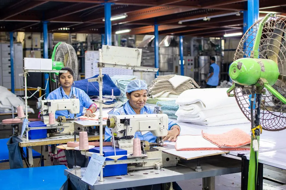 Workers at sewing machines in a garment production line